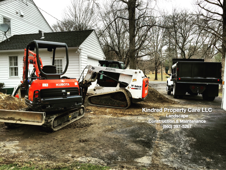 Excavating and installing drainage system